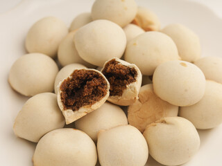 Pastry ball with chocolate filling on white background