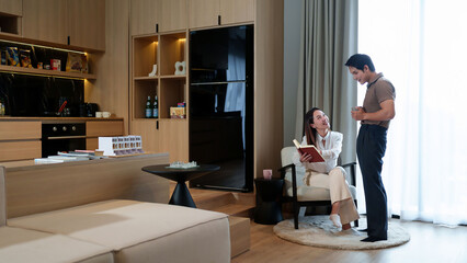 Asian Couple Relaxing in Modern Apartment with Open Floor Plan Reading Book Enjoying Coffee Luxury Living Space Apartment Interior Design