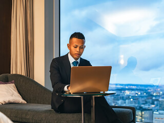 Businessman working on a laptop in a high-rise office