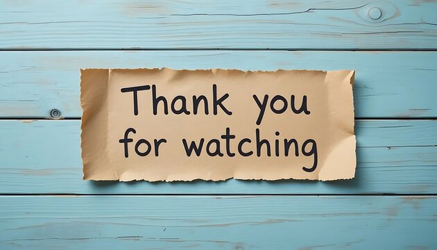Torn paper note with thank you for watching text on blue wooden background. Ideal for video outros, presentations, and social media end screens.