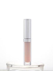 Sleek transparent cosmetic container with metallic cap, ideal for lip gloss, concealer, or serum. Clean, professional presentation for beauty product advertising or branding.