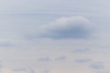 The lightly overcast sky is covered with clouds.