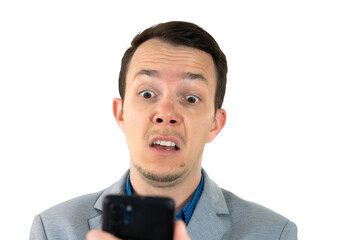 Surprised man in suit looking at smartphone with shocked expression, isolated png portrait, concept...