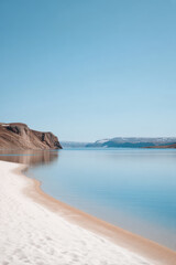 serene beach in nunavut canada with soft white sands and gentle waves lapping at shore