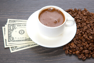 Enjoying a rich cup of coffee with fresh beans and a touch of cash on a wooden table. coffee business