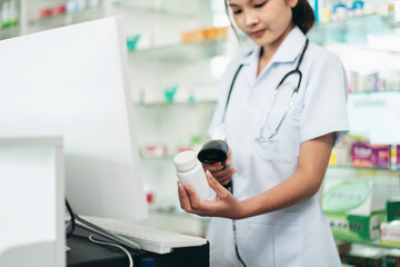 She is using a barcode scanner to check the contents of the bottle