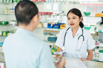 A woman in a white uniform is talking to a man in a blue shirt