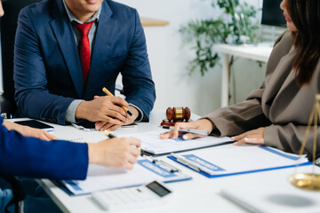 Justice and law concept.Male judge in a courtroom on white table and Counselor or team Male lawyer working
