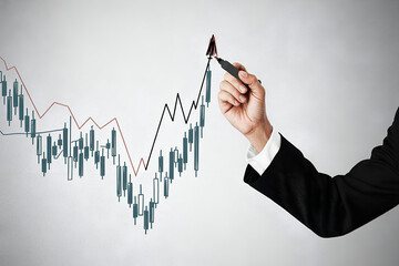 Hand in suit drawing rising stock market graph on white background
