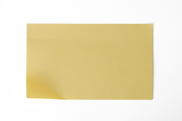 The Photo of a yellow notepaper on a white background, taken with a 45Mp high resolution camera.