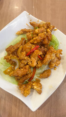 Fried chicken butter sauce with olives close-up.
