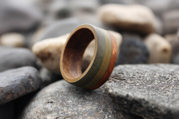 Handcrafted ring shines with natural beauty on river stones