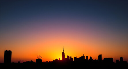 Naklejka premium City at sunset, Urban sunset scene, Sunset over city, City skyline sunset, Cityscape at dusk, Golden hour city, Sunset buildings, Evening city lights, Sunset horizon city, City during twilight, Glowin