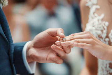 Fototapeta premium Couple exchanges rings, feeling happy at wedding day celebration moment