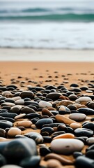 Obraz premium Ocean Beach Stones: Smooth Pebbles and Tranquil Waves