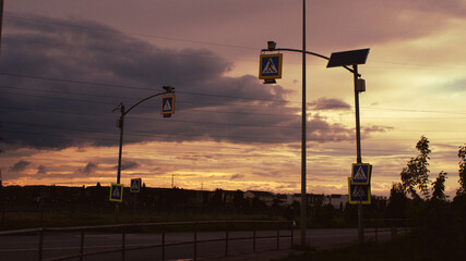 Sunset over a quiet road with pedestrian signs