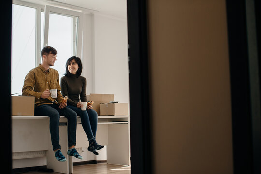 Happy couple taking a break while moving into new home