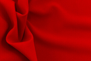 Red Silk, satin fabric texture with folds and waves. Textile. Material. Fashion