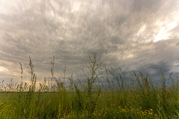 Dark ominous thunderstorm clouds over Bavaria field showing supercell rotation extreme weather...
