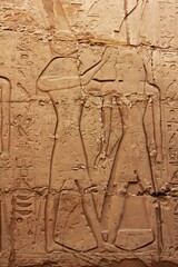 Montu crowns Ramses. Ancient drawings and hieroglyphs on the wall of the Karnak Temple in Luxor, Egypt.