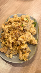 Salty Fried Chicken Skin coated in a spicy flour and deep fried served on a plate
