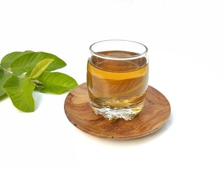 Guava leaf boiled water in glass and fresh guava leaves. Healthy drink lifestyle 