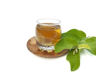 Guava leaf boiled water in glass and fresh guava leaves. Healthy drink lifestyle 