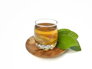 Guava leaf boiled water in glass and fresh guava leaves. Healthy drink lifestyle 