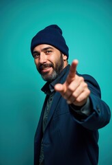Charming businessman with beard and beanie, pointing