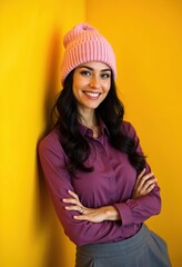 Charming creative woman with beanie, yellow background
