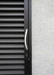 Aluminium door frame on terrazzo or gravel wall