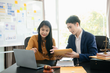 Asian lawyers in a modern office discussing contracts, law, and justice. Collaboration, documents, and determination showcased