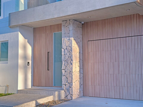 Timber front door and garage of a new modern two storey house