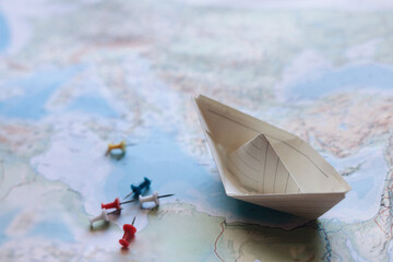A minimalist paper boat floats above the map journeys concept.