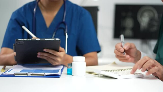 Medical team working on digital tablet healthcare doctor technology tablet using computer analyzed the results of medical reports at the hospital.