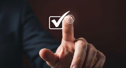 Businessman's finger touching check mark icon with smiling face emoticon on dark background. Concept of service rating, customer satisfaction, quality feedback, and positive review.