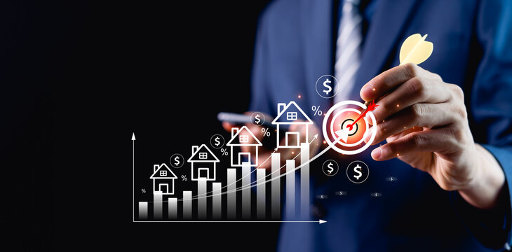 Businessman planning finance, commercial real estate investment, home insurance, real estate investment concept with virtual house icon showing mortgage analysis.
