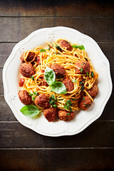 Spaghetti Pasta with Meatballs and fresh Basil. Close up.