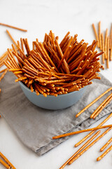 Organic Salty Pretzel Sticks in a Bowl, side view.