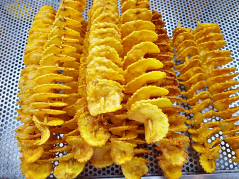 Spiral fried potato ( thinly sliced fried potato chips skewers).