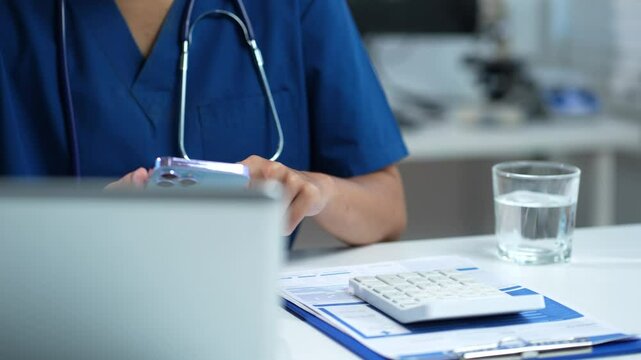 Doctor use a service fee calculator to save money on health insurance, drug cost concept.