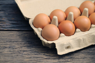 A close-up view of a stack of eggs neatly arranged in a carton. 