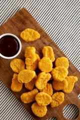 Organic Fried Chicken Nuggets on a wooden board, top view. Copy space.
