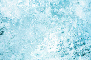 Water splashes creating bubbles under bright sunlight on a clear day by the poolside