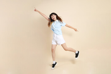 20s Asian Woman in Light Blue Shirt and White Shorts