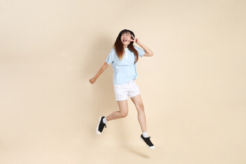 Fototapeta premium 20s Asian Woman in Light Blue Shirt and White Shorts