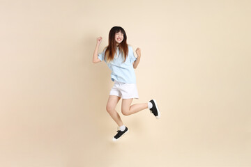 20s Asian Woman in Light Blue Shirt and White Shorts