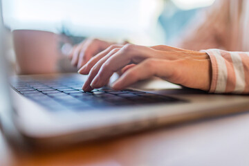 Close up of female finger using laptop trackpad scrolling website for online shopping and browsing. Distance learning.