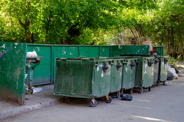 Dirty city dumpsters overflowing with garbage