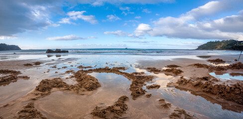Hot Water Beach on the east coast of the Coromandel Peninsula, New Zealand's North Island. Underground hot springs filter up through the sand between the high and low water tidal reaches